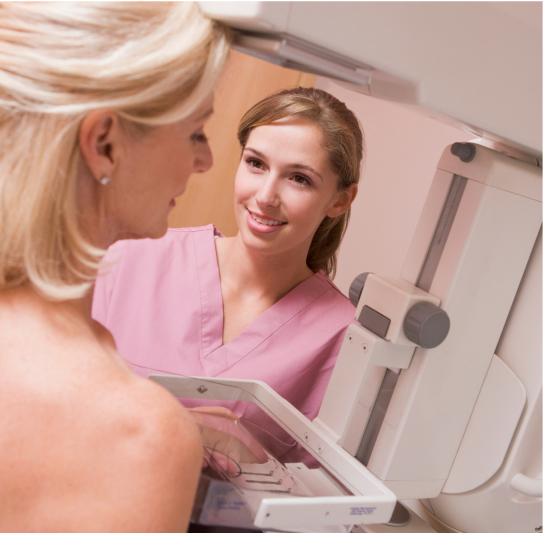 nurse assisting patient undergoing mammogram