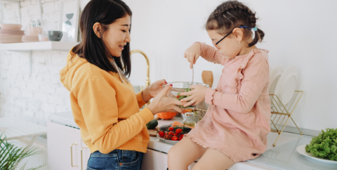 mother and daughter eating salad