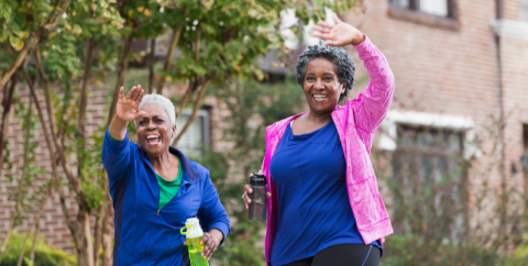 two women walking and smiling