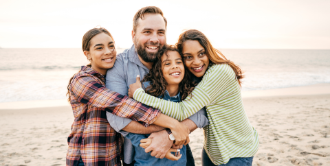 Mother and father with two teen girls on a beach