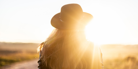 woman wearing a wide brimmed hat in the fall sun